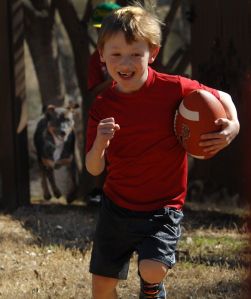 Zach and his dog, Max, play football. From 2014